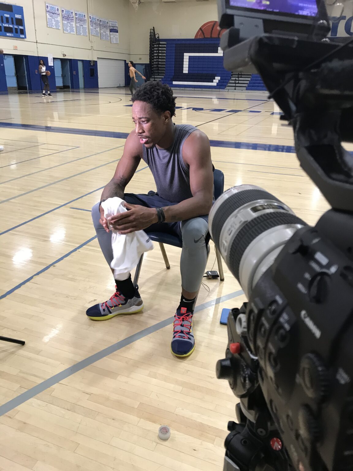 Filming a basketball player interview on the court