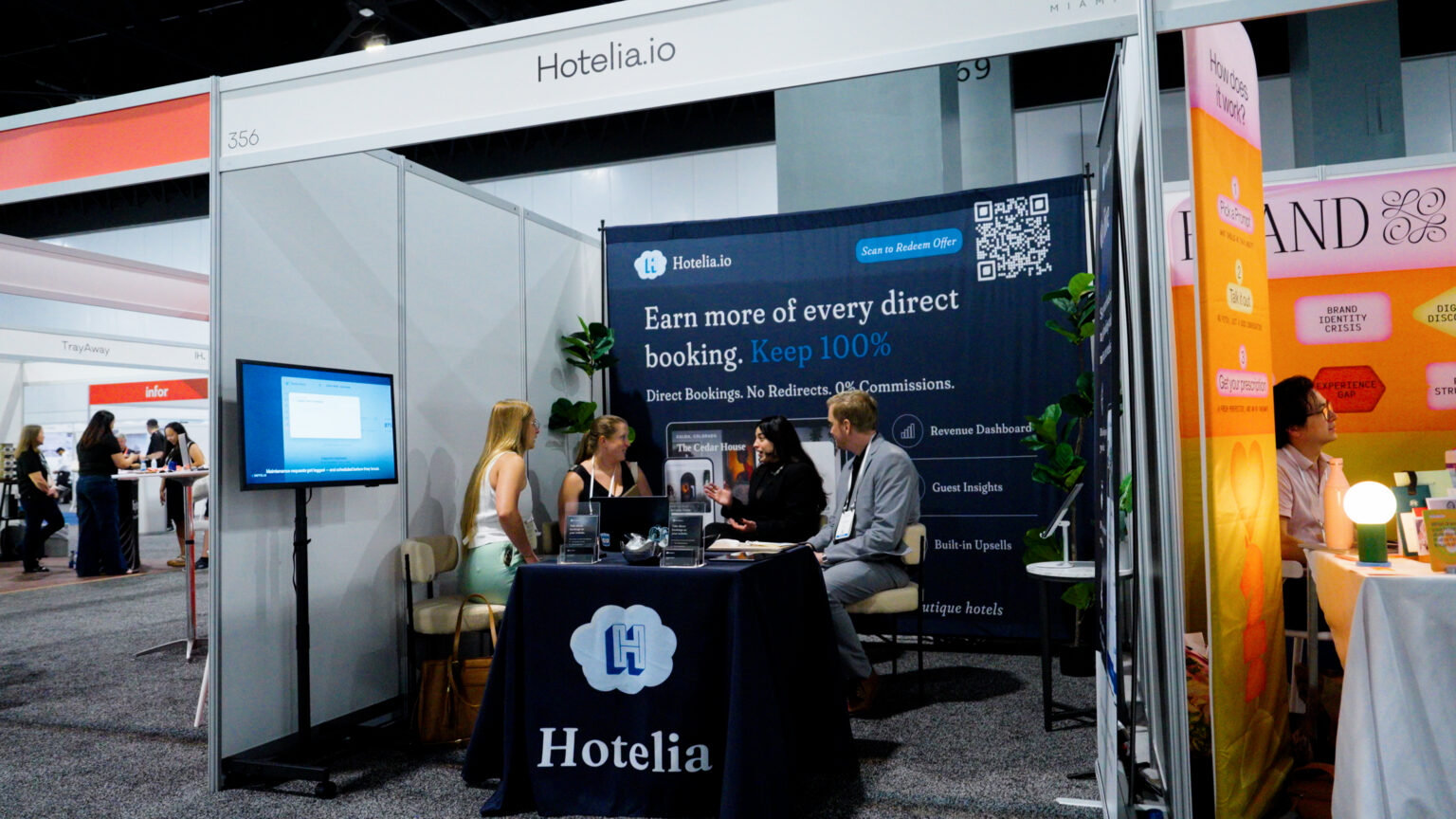 Exhibitor booth conversations on the show floor at the Miami Beach Convention Center